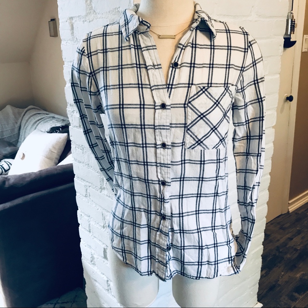 Plaid, white and black buttoned down shirt.